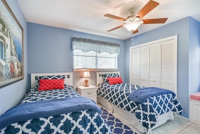 tiled bedroom with a closet and ceiling fan