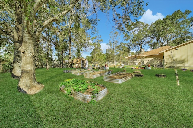 view of yard featuring a vegetable garden and fence