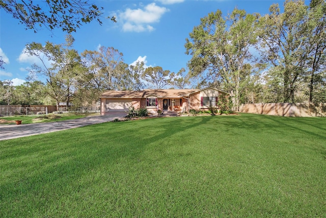 ranch-style home featuring driveway, a front lawn, an attached garage, and fence