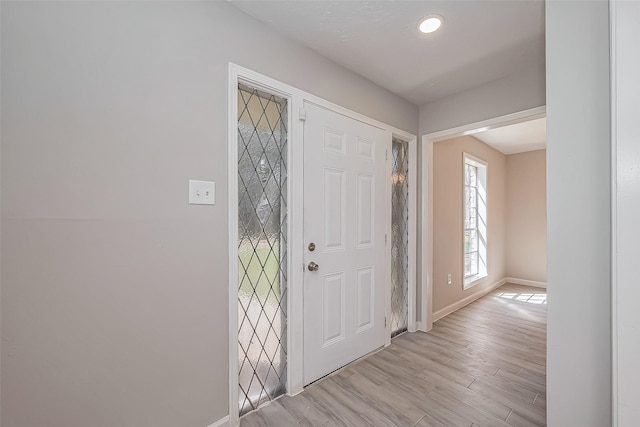 entryway featuring baseboards and light wood-style floors