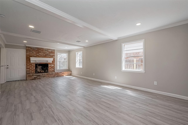 unfurnished living room with wood finished floors, baseboards, visible vents, and ornamental molding