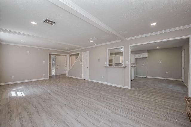 unfurnished living room featuring visible vents, baseboards, crown molding, and light wood finished floors