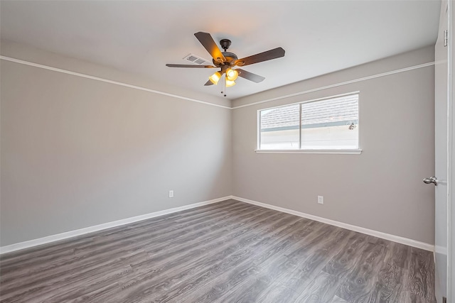 empty room with visible vents, baseboards, dark wood-type flooring, and ceiling fan