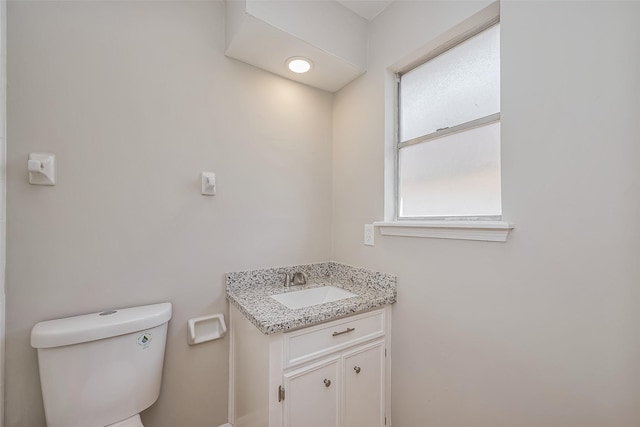 bathroom featuring toilet and vanity