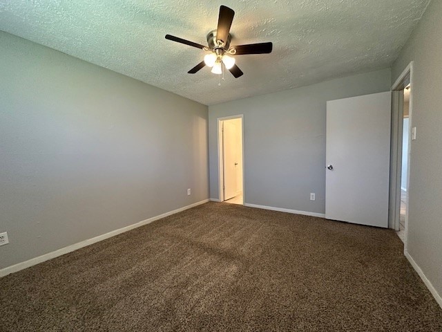 unfurnished bedroom with ceiling fan, carpet flooring, baseboards, and a textured ceiling