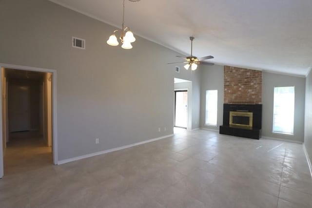 unfurnished living room with visible vents, ceiling fan with notable chandelier, a brick fireplace, and baseboards