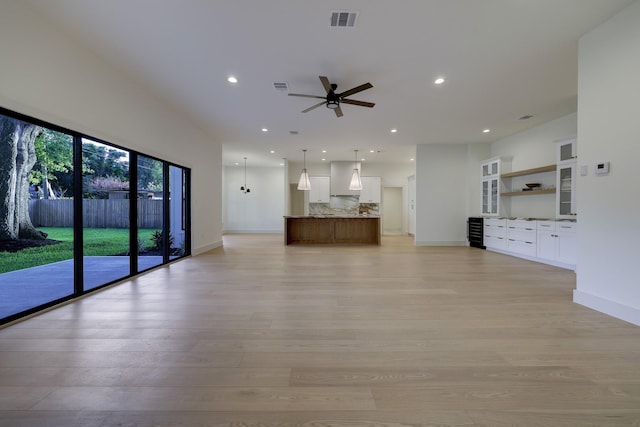 unfurnished living room featuring light wood-style flooring, recessed lighting, visible vents, and baseboards