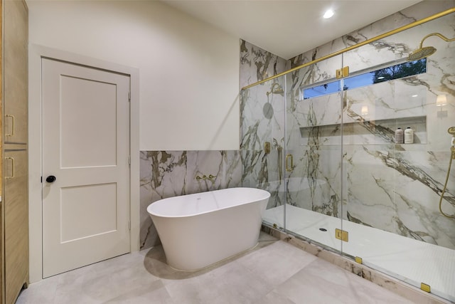 full bathroom with a marble finish shower, a soaking tub, and tile walls