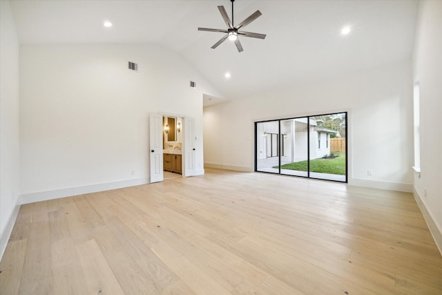 empty room featuring baseboards, visible vents, high vaulted ceiling, ceiling fan, and light wood-type flooring