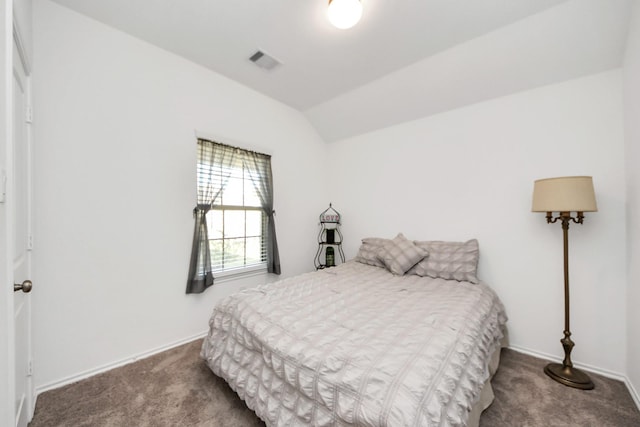 carpeted bedroom with vaulted ceiling, baseboards, and visible vents