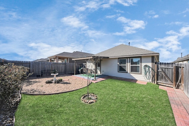 back of property with a patio, a gate, a fenced backyard, a shingled roof, and a lawn