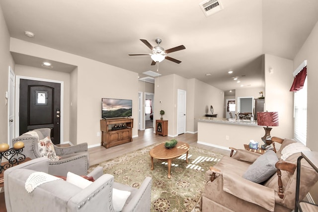 living room featuring visible vents, wood finished floors, recessed lighting, baseboards, and attic access