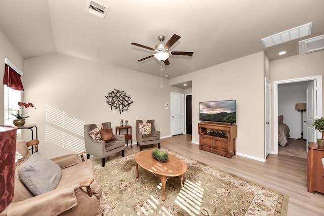 living area with ceiling fan, attic access, visible vents, and light wood-type flooring