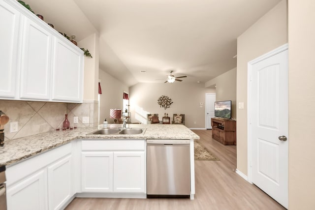 kitchen featuring ceiling fan, dishwasher, a peninsula, white cabinetry, and a sink