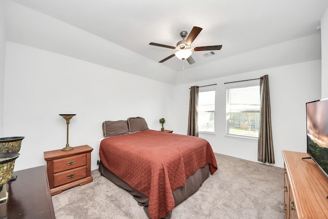 bedroom with a ceiling fan, visible vents, and light carpet