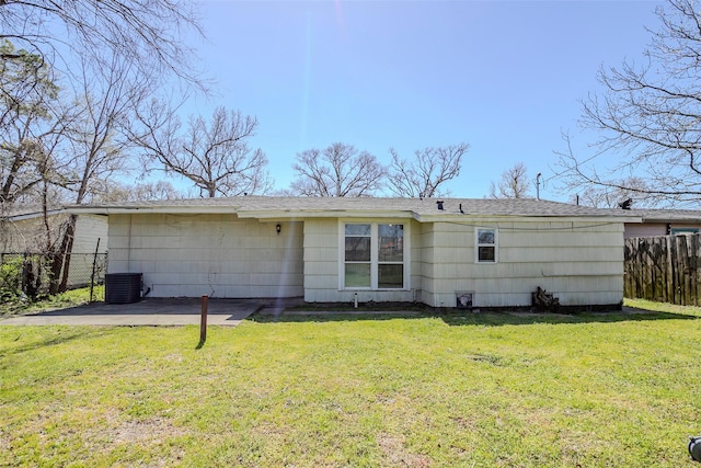 back of house with a patio area, a lawn, central AC unit, and fence