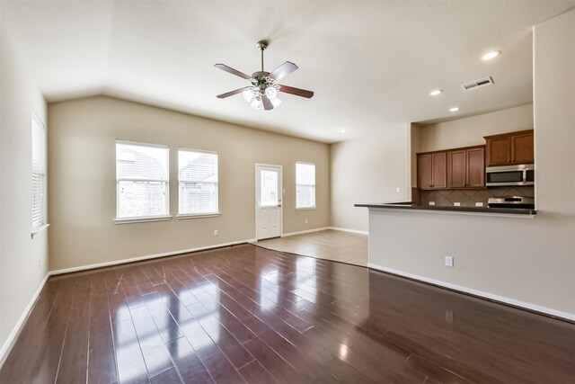 unfurnished living room featuring ceiling fan, visible vents, baseboards, and wood finished floors