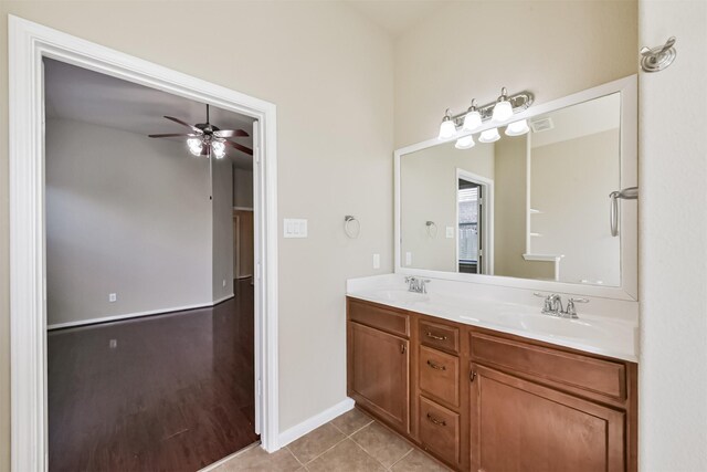 bathroom with tile patterned flooring, double vanity, a ceiling fan, and a sink