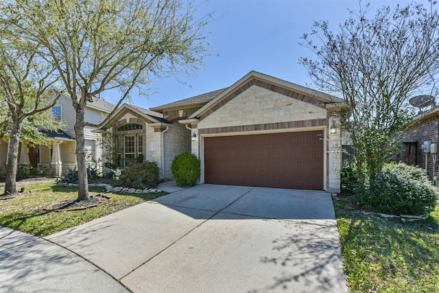 view of front facade with an attached garage, stone siding, and driveway