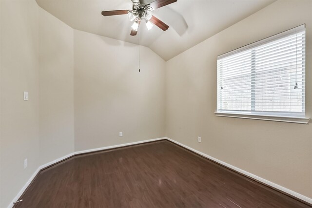 unfurnished room featuring dark wood finished floors, baseboards, lofted ceiling, and a ceiling fan