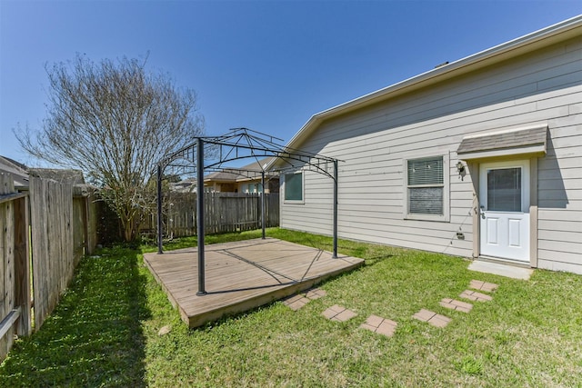 view of yard featuring a gazebo, a deck, and a fenced backyard