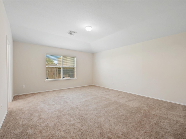 carpeted empty room with visible vents and baseboards