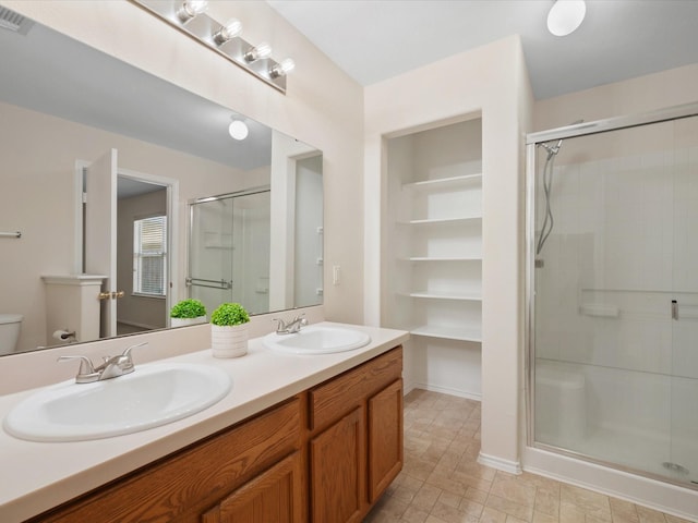 full bathroom with a sink, visible vents, double vanity, and a shower stall