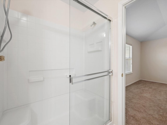 full bath with an enclosed shower, baseboards, and vaulted ceiling