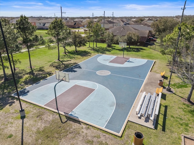 view of basketball court featuring a lawn and basketball court