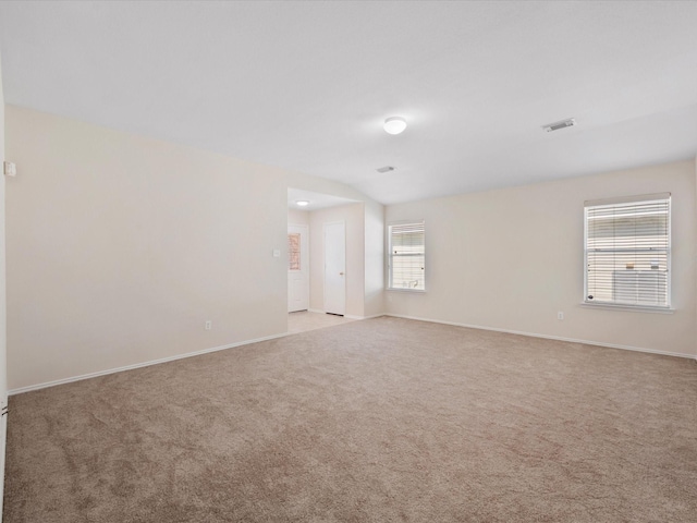 unfurnished room with visible vents, baseboards, and carpet floors