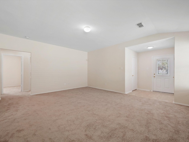 unfurnished room featuring visible vents, light carpet, and baseboards