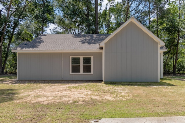 exterior space with a front lawn and roof with shingles