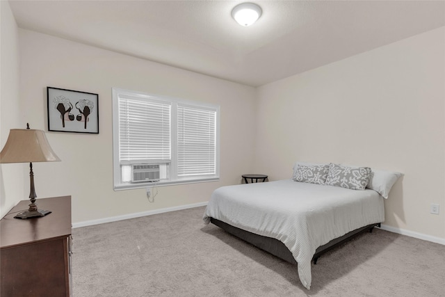 bedroom with cooling unit, baseboards, and carpet flooring