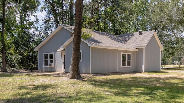 view of home's exterior featuring a yard, cooling unit, and fence