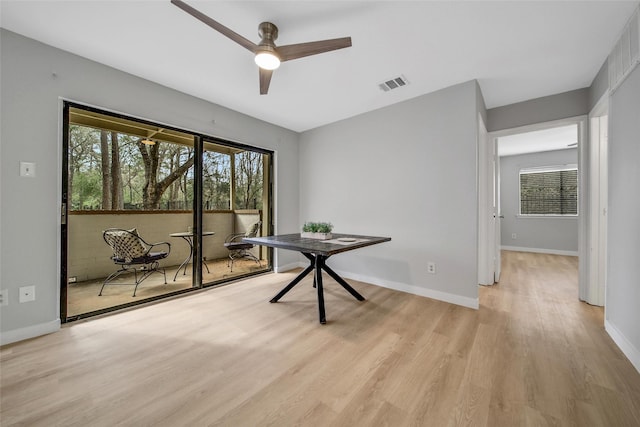 unfurnished dining area with visible vents, baseboards, light wood-style floors, and a ceiling fan