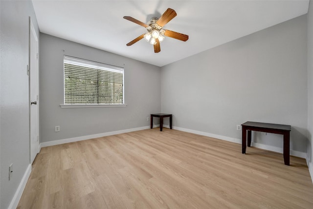 empty room featuring light wood-style floors, baseboards, and ceiling fan