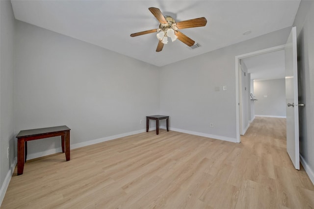 spare room with ceiling fan, baseboards, visible vents, and light wood-type flooring