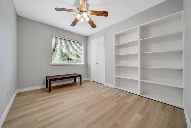 unfurnished bedroom with ceiling fan, baseboards, and wood finished floors