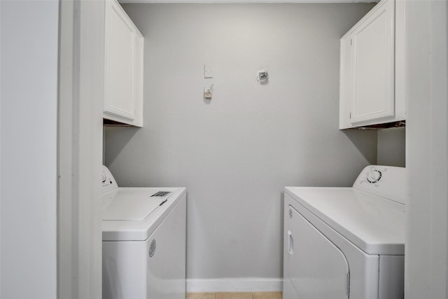 laundry area featuring cabinet space, washing machine and dryer, and baseboards