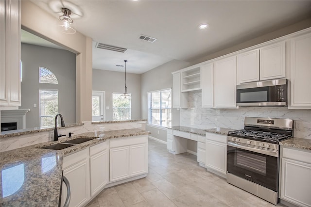 kitchen with tasteful backsplash, visible vents, appliances with stainless steel finishes, and a sink