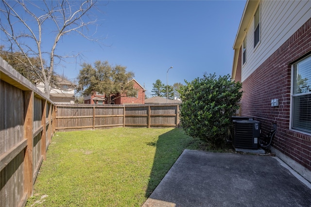 view of yard featuring a patio, central AC unit, and a fenced backyard