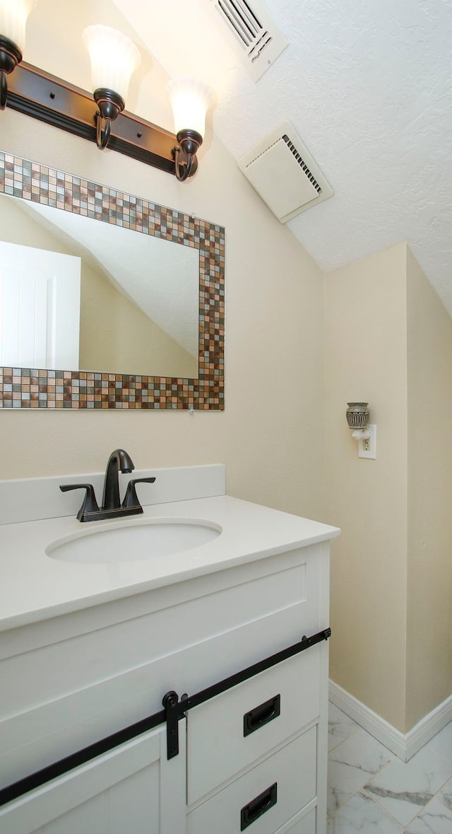 bathroom featuring visible vents, marble finish floor, vanity, and baseboards