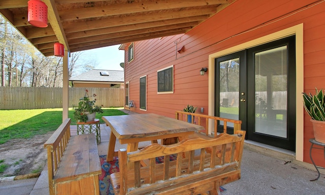 view of patio with outdoor dining space and fence