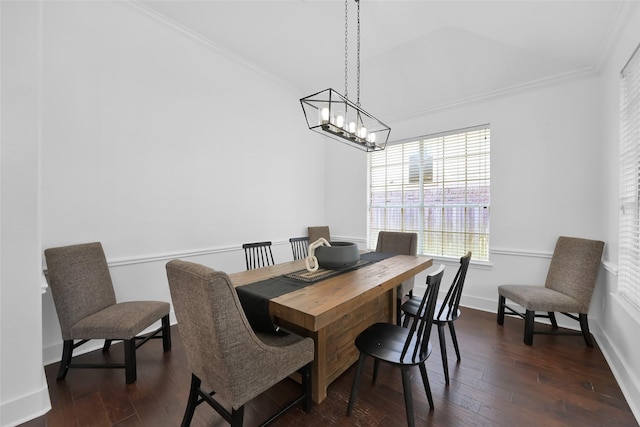 dining area featuring dark wood finished floors, baseboards, and ornamental molding