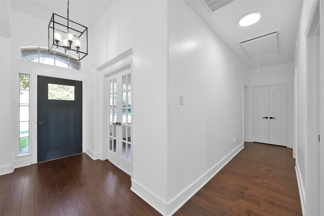 entrance foyer with dark wood finished floors, visible vents, plenty of natural light, and baseboards