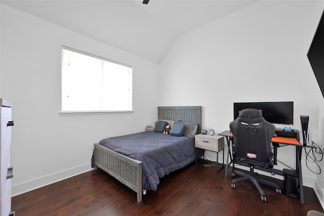 bedroom with lofted ceiling, baseboards, and wood-type flooring