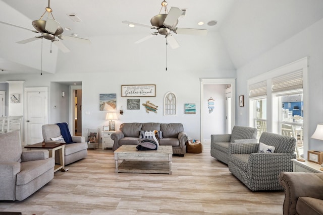 living room with high vaulted ceiling, a ceiling fan, and light wood finished floors