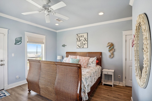 bedroom featuring crown molding, wood finished floors, visible vents, and baseboards