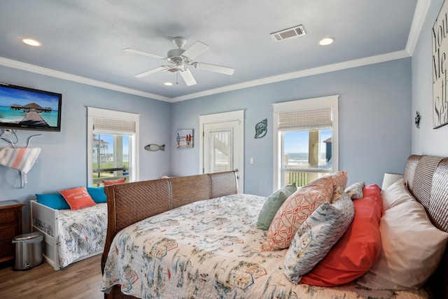 bedroom with a ceiling fan, wood finished floors, visible vents, recessed lighting, and crown molding