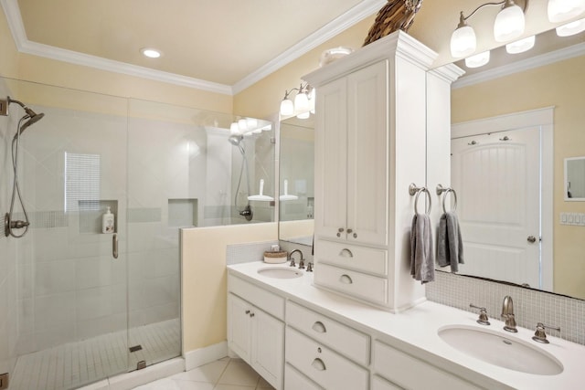 bathroom with a sink, a shower stall, crown molding, and double vanity